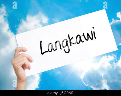 Langkawi  Sign on white paper. Man Hand Holding Paper with text. Isolated on sky background.  Business concept. Stock Photo Stock Photo