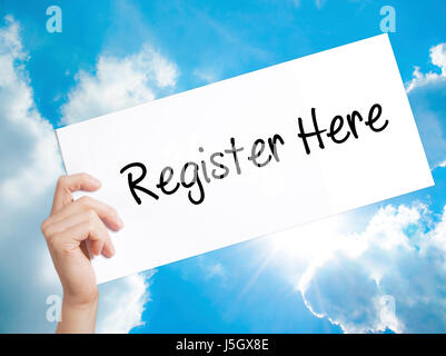 Register Here Sign on white paper. Man Hand Holding Paper with text. Isolated on sky background.   Business concept. Stock Photo Stock Photo