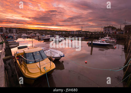 West Bay, Dorset, UK. 17th May, 2017. UK Weather. The harbour with the warm glow of a spectacular sunset above to finish the day at the seaside resort of West Bay in Dorset as the clouds break up after a day of heavy persistent rain. Picture by Credit: Graham Hunt/Alamy Live News Stock Photo