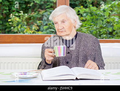 Senior lady enjoying a cup of coffee Stock Photo