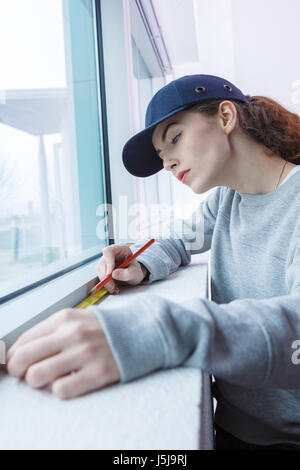 Woman measuring window Stock Photo