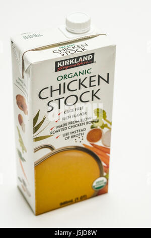 A one quart carton of Kirkland Signature organic chicken stock, vertical image, white background Stock Photo