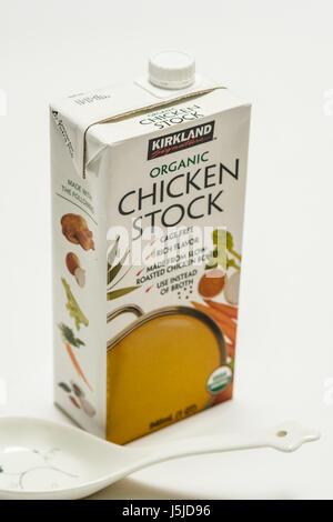 A one quart carton of Kirkland Signature organic chicken stock, vertical image, white background Stock Photo