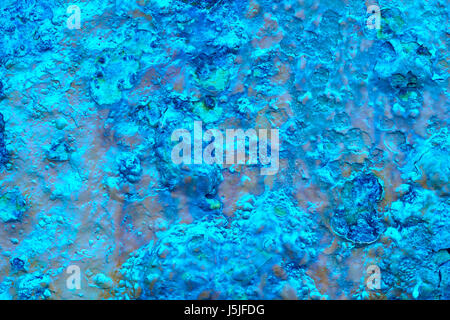 Blue paint over a metallic textured and rusty background. Horizontal Stock Photo