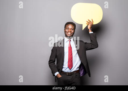 Handsome Afro American man in classic suit is holding a speech bubble and thinking Stock Photo