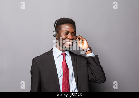 Closeup portrait of a young male customer service representative or call centre worker or operator, support staff speaking with head set Stock Photo