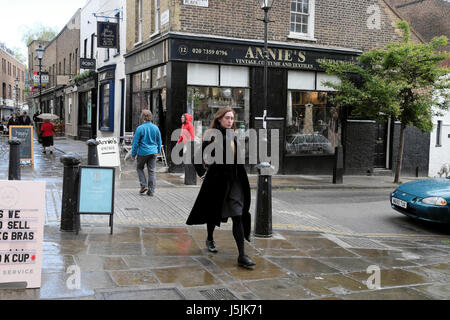 https://l450v.alamy.com/450v/j5jk71/an-attractive-young-woman-walking-along-street-camden-passage-upper-j5jk71.jpg