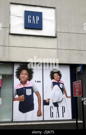 Gap Kids advert with boy in summer tshirt and jeans on the wall outside a Gap clothing store in London UK   KATHY DEWITT Stock Photo