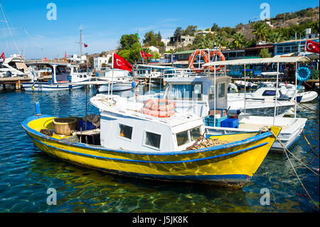Scenic view of boats in the marina of a traditional Mediterranean fishing village in the seaside tourist village of Gumusluk, near Bodrum, Turkey Stock Photo