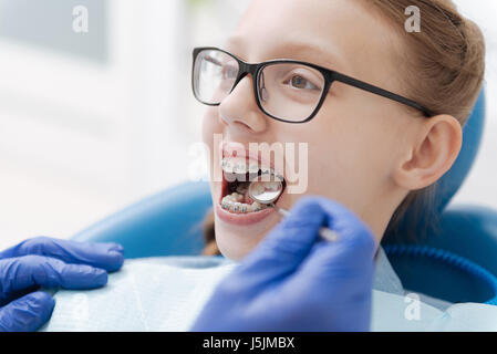 Sweet ginger girl undergoing examining procedure Stock Photo