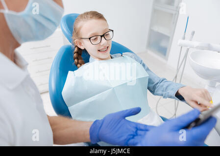 Inventive prominent dentist using gadget for educational purposes Stock Photo