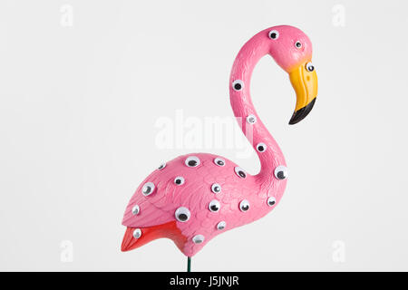 quirky and freak pink plastic flamingo on a pink background with numerous eyes gradient and tones on tones Stock Photo