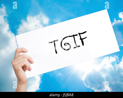 TGIF Sign on white paper. Man Hand Holding Paper with text. Isolated on sky background.   Business concept. Stock Photo Stock Photo