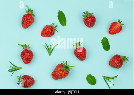 Seamless pattern of strawberries and mint, top view flat lie on light blue background Stock Photo