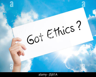 Got Ethics Sign on white paper. Man Hand Holding Paper with text. Isolated on sky background.  Business concept. Stock Photo Stock Photo