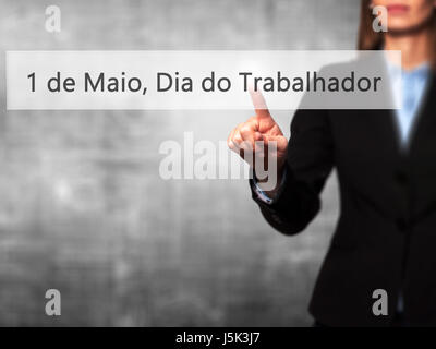 1 de Maio, Dia do Trabalhador (In Portuguese: 1 May, Labor Day) - Isolated female hand touching or pointing to button. Business and future technology  Stock Photo