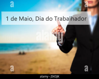 1 de Maio, Dia do Trabalhador (In Portuguese: 1 May, Labor Day) - Isolated female hand touching or pointing to button. Business and future technology  Stock Photo