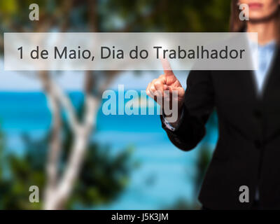 1 de Maio, Dia do Trabalhador (In Portuguese: 1 May, Labor Day) - Isolated female hand touching or pointing to button. Business and future technology  Stock Photo