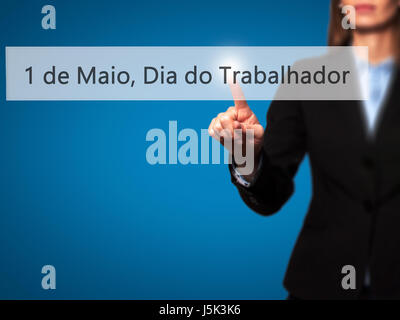 1 de Maio, Dia do Trabalhador (In Portuguese: 1 May, Labor Day) - Isolated female hand touching or pointing to button. Business and future technology  Stock Photo