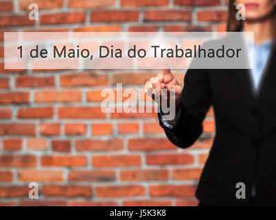 1 de Maio, Dia do Trabalhador (In Portuguese: 1 May, Labor Day) - Isolated female hand touching or pointing to button. Business and future technology  Stock Photo