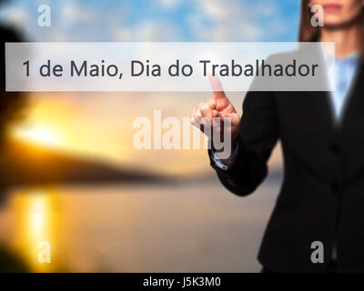 1 de Maio, Dia do Trabalhador (In Portuguese: 1 May, Labor Day) - Isolated female hand touching or pointing to button. Business and future technology  Stock Photo