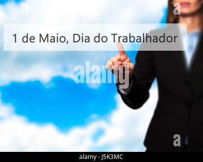 1 de Maio, Dia do Trabalhador (In Portuguese: 1 May, Labor Day) - Isolated female hand touching or pointing to button. Business and future technology  Stock Photo