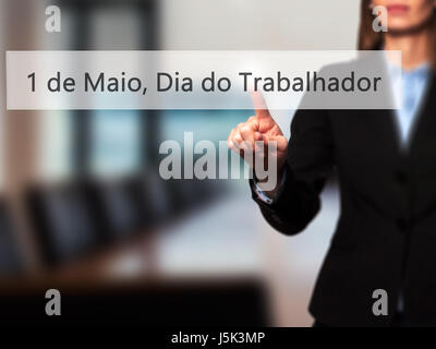 1 de Maio, Dia do Trabalhador (In Portuguese: 1 May, Labor Day) - Isolated female hand touching or pointing to button. Business and future technology  Stock Photo