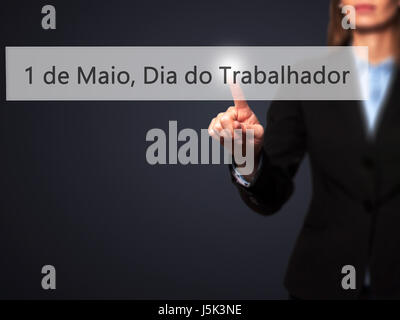 1 de Maio, Dia do Trabalhador (In Portuguese: 1 May, Labor Day) - Isolated female hand touching or pointing to button. Business and future technology  Stock Photo