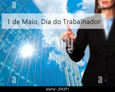 1 de Maio, Dia do Trabalhador (In Portuguese: 1 May, Labor Day) - Isolated female hand touching or pointing to button. Business and future technology  Stock Photo