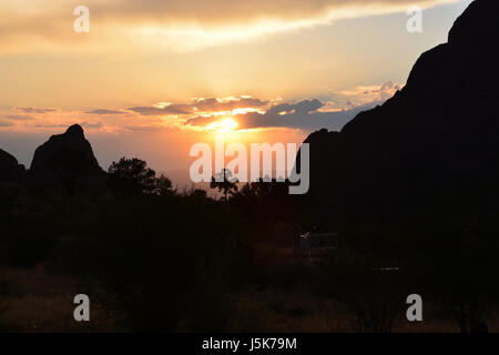 The sun sets through the Window at Chisos Mountain Basin in Big Bend National Park in Texas Stock Photo
