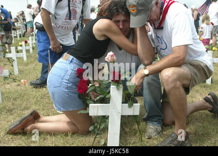 A man is overcome with emotion while placing a flower on a cross at Camp Casey II. (Photo by Jeremy Hogan)Protests against George W Bush take place near his home in Crawford, Texas over the summer of 2005. Anti-War activist Cindy Sheehan had begun the protests after her son Casey Sheehan was killed in Iraq during the U.S. invasion. Sheehan demanded that Bush talk to her about the war, and when he didn't, she set up a protest outside his ranch. Stock Photo