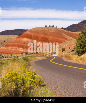 The road winds through colorful mineral and rock deposits in Oregon Stock Photo