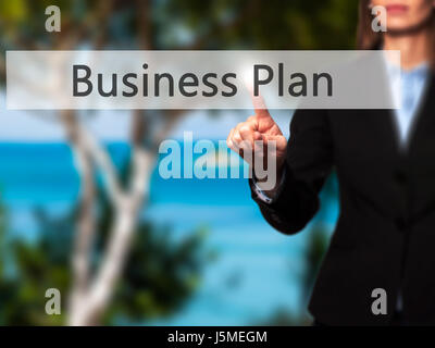 Business Plan - Businesswoman pressing high tech  modern button on a virtual background. Business, technology, internet concept. Stock Photo Stock Photo