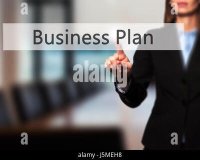 Business Plan - Businesswoman pressing high tech  modern button on a virtual background. Business, technology, internet concept. Stock Photo Stock Photo