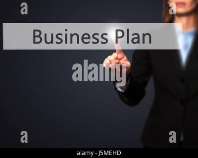 Business Plan - Businesswoman pressing high tech  modern button on a virtual background. Business, technology, internet concept. Stock Photo Stock Photo