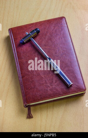 Leather notebook of the neurologist on the table with a medical tool Stock Photo