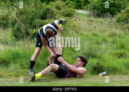 Runner with hamstring problem in Stratford Triathlon being helped by fellow runner, Stratford-upon-Avon, UK Stock Photo