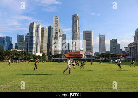 Singapore. 18th May 2017. British expatriots play a soccer game on a hot humid day with a view of Singapore skyline and financial business district Credit: amer ghazzal/Alamy Live News Stock Photo