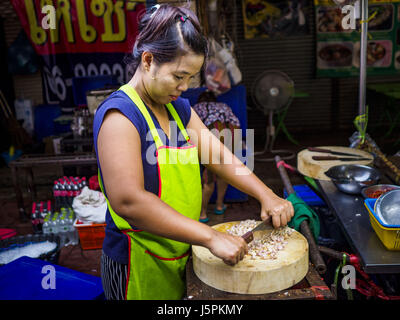 Bangkok, Bangkok, Thailand. 18th May, 2017. A vendor cuts up garlic at the food stall Bangkok's Chinatown. City officials in Bangkok have taken steps to rein in street food vendors. The steps were originally reported as a ''ban'' on street food, but after an uproar in local and international news outlets, city officials said street food vendors wouldn't be banned but would be regulated, undergo health inspections and be restricted to certain hours on major streets. On Yaowarat Road, in the heart of Bangkok's touristy Chinatown, the city has closed some traffic lanes to facilitate the vendors. Stock Photo