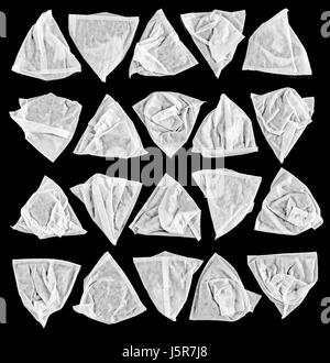 Monochrome image of white pyramid tea bags arranged on a black background. Stock Photo