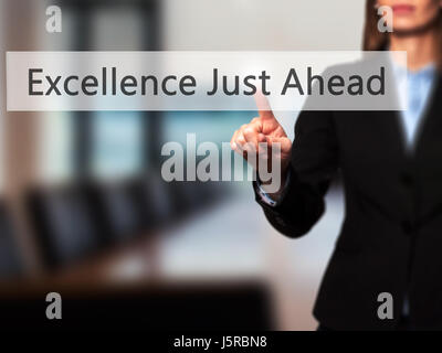 Excellence Just Ahead - Businesswoman hand pressing button on touch screen interface. Business, technology, internet concept. Stock Photo Stock Photo