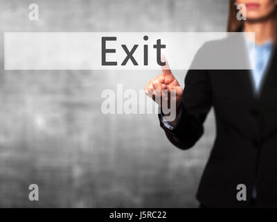 Exit - Businesswoman hand pressing button on touch screen interface. Business, technology, internet concept. Stock Photo Stock Photo