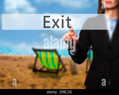 Exit - Businesswoman hand pressing button on touch screen interface. Business, technology, internet concept. Stock Photo Stock Photo
