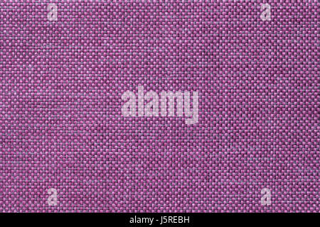 Dark violet woolen background of dense woven bagging fabric, closeup. Structure of the purple cloth with natural texture. Cloth backdrop. Stock Photo