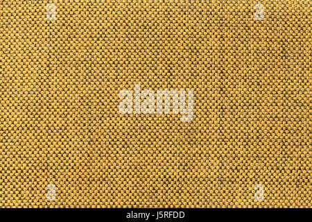 Dark yellow background with checkered pattern, closeup. Structure of the golden fabric with natural texture. Cloth backdrop. Stock Photo