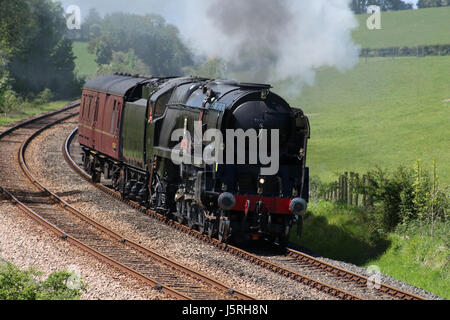 Restored Merchant Navy class steam locomotive 35018 British India Line on a light test run passing Starricks farm near Borwick, Lancashire, England. Stock Photo