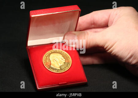 hand presentation currency austrians coin metal bright shiny noble valuable Stock Photo