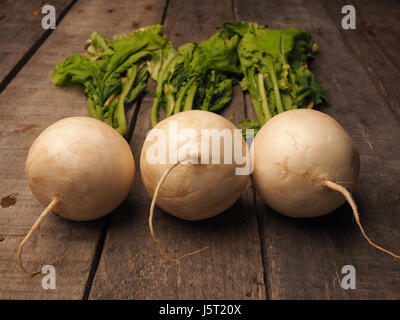May turnip on a rustic wooden table with space for text Stock Photo