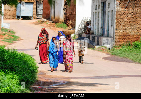 Khajuraho, India, september 17, 2010: Indian woman and children waking in a village in india, sunny day, summer time. Stock Photo