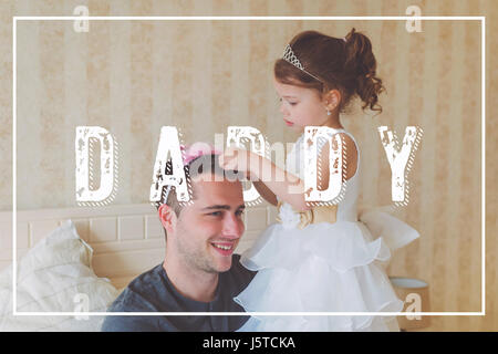 Little girl with father wearing crowns. Fathers day concept. Stock Photo